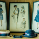 A close up of images and hats depicting Luther College uniforms of yesteryear