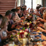 Luther College alumni dine at a lengthy banquet table