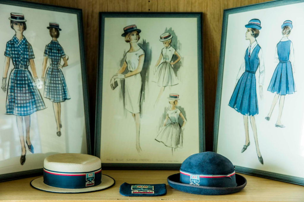 A close up of images and hats depicting Luther College uniforms of yesteryear